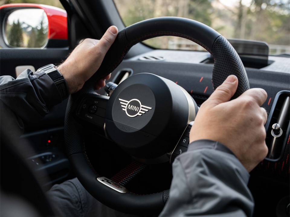 MINI steering wheel with logo and two hands MINI steering wheel with logo and two hands